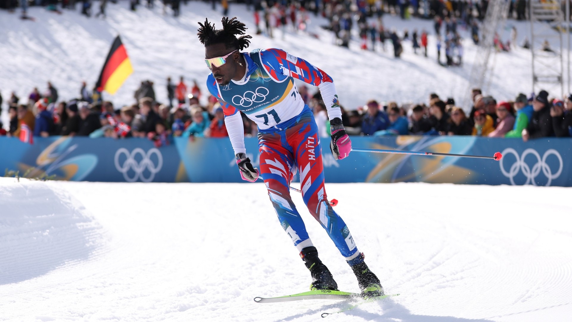 Haiti's first Olympic cross-country skier celebrated by crowd after jubilant finish in men's skiathlon